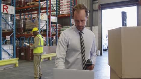 male warehouse manager working in loading bay 4k