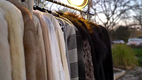 clothes hang outside on a rack