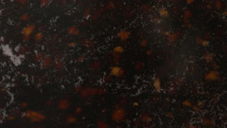 a detailed close-up, slow-motion of tea particles boiling in water with steam, preparing a hot drink
