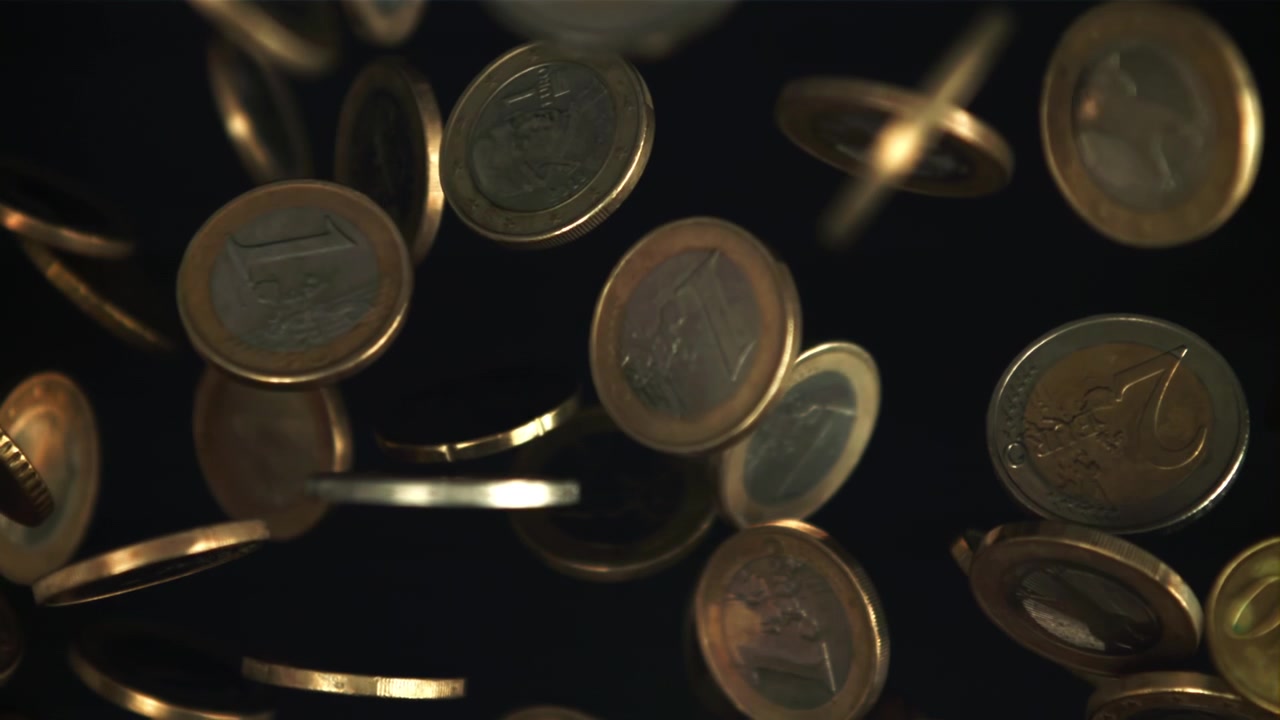 Euro Coins Falling in Slow Motion on a Dark Background