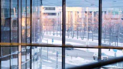 city street view through a modern building's windows in winter