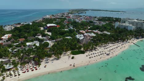 aerial view over the playa norte beach and the village of isla mujeres island in sunny mexico - rising, drone shot