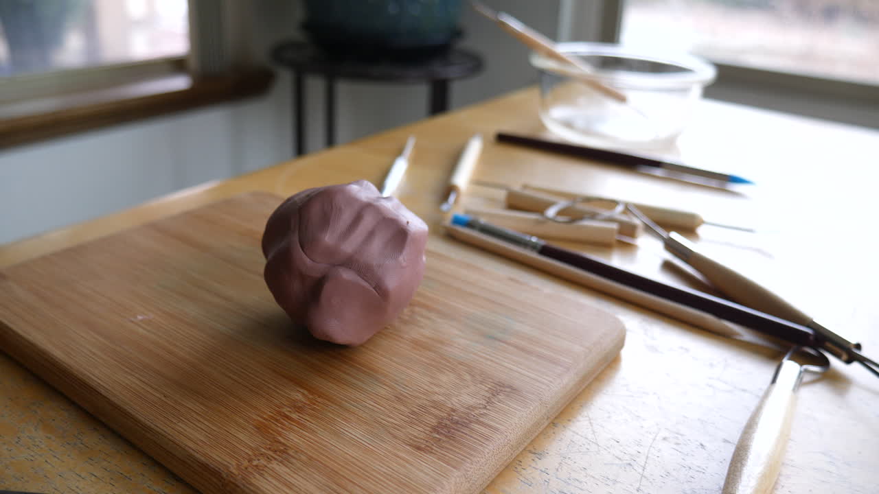 Modeling clay and tools on a wooden board
