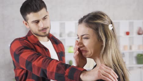 the girlfriend of the young man who is sweating at home is disturbed and disgusted by the smell.