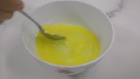 whisking egg in a small bowl