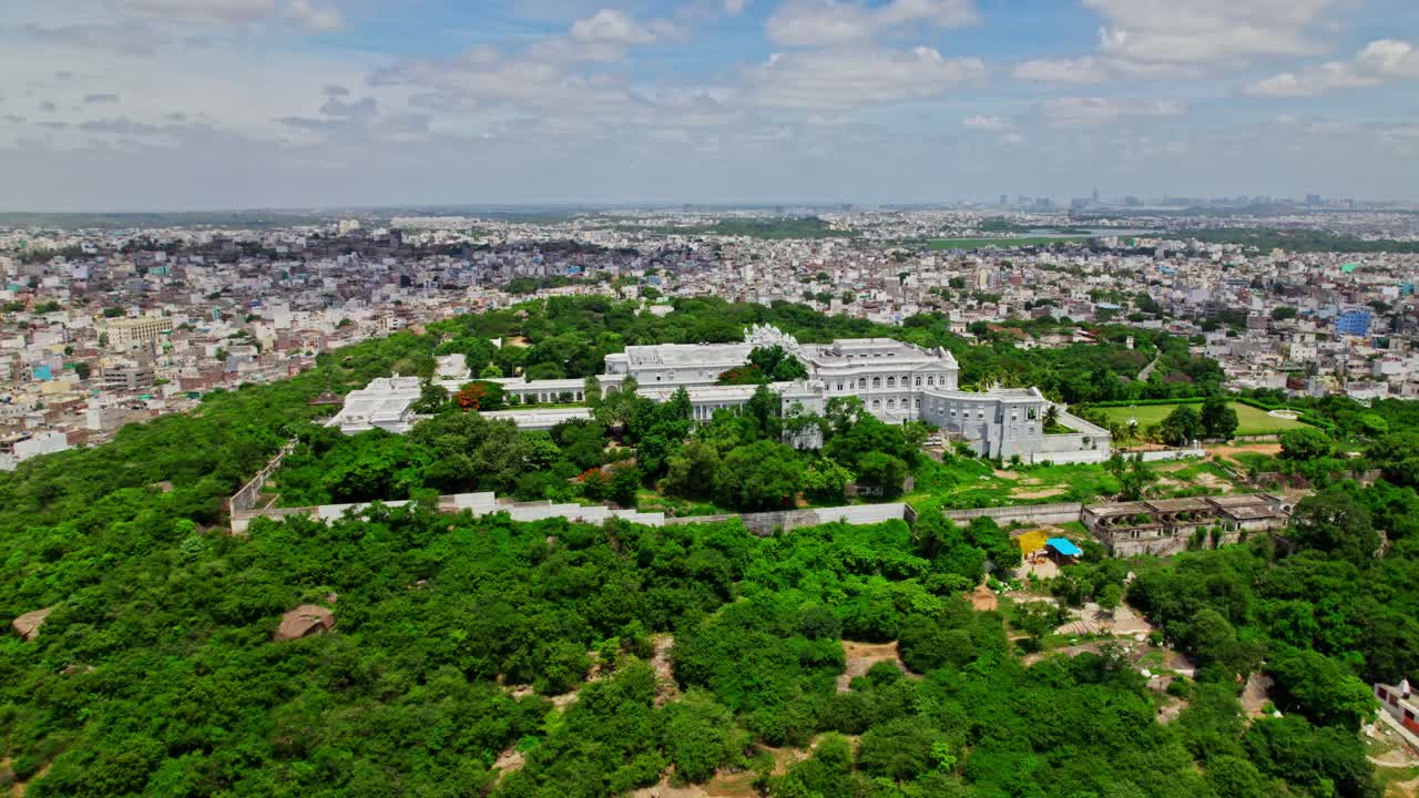 Hyderabad city aerial view with taj falaknuma palace, greenery, trees, and clouds at engine bowli, falaknuma, hyderabad, telangana, india. day time, semi circle, drone shot, 4k.