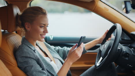 Side-view-of-woman-holding-phone-at-car.-Businesswoman-sitting-with-phone-at-car