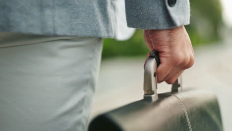 man in suit walking down the street with a briefcase