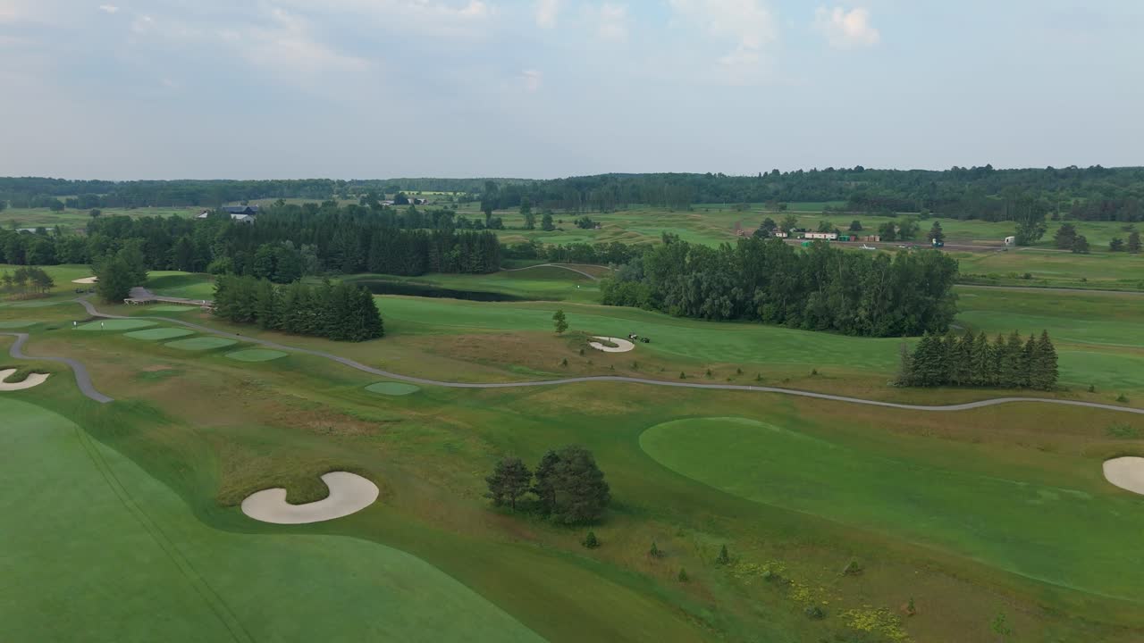 Aerial view of TPC golf course, lush green fairways, serene landscape