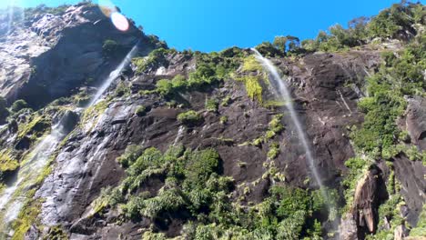 inside beautiful waterfalls while cruising around milford sound in new zealand