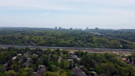 drone flying toward qew in mississauga with lake ontario in the distance