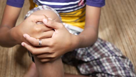 child holding sore knee