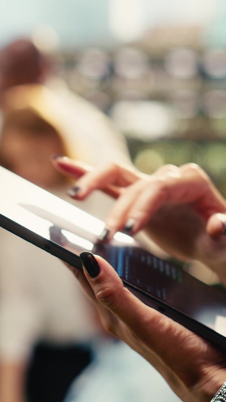 Vertical Video Close up of businesswoman holding tablet and reading notes