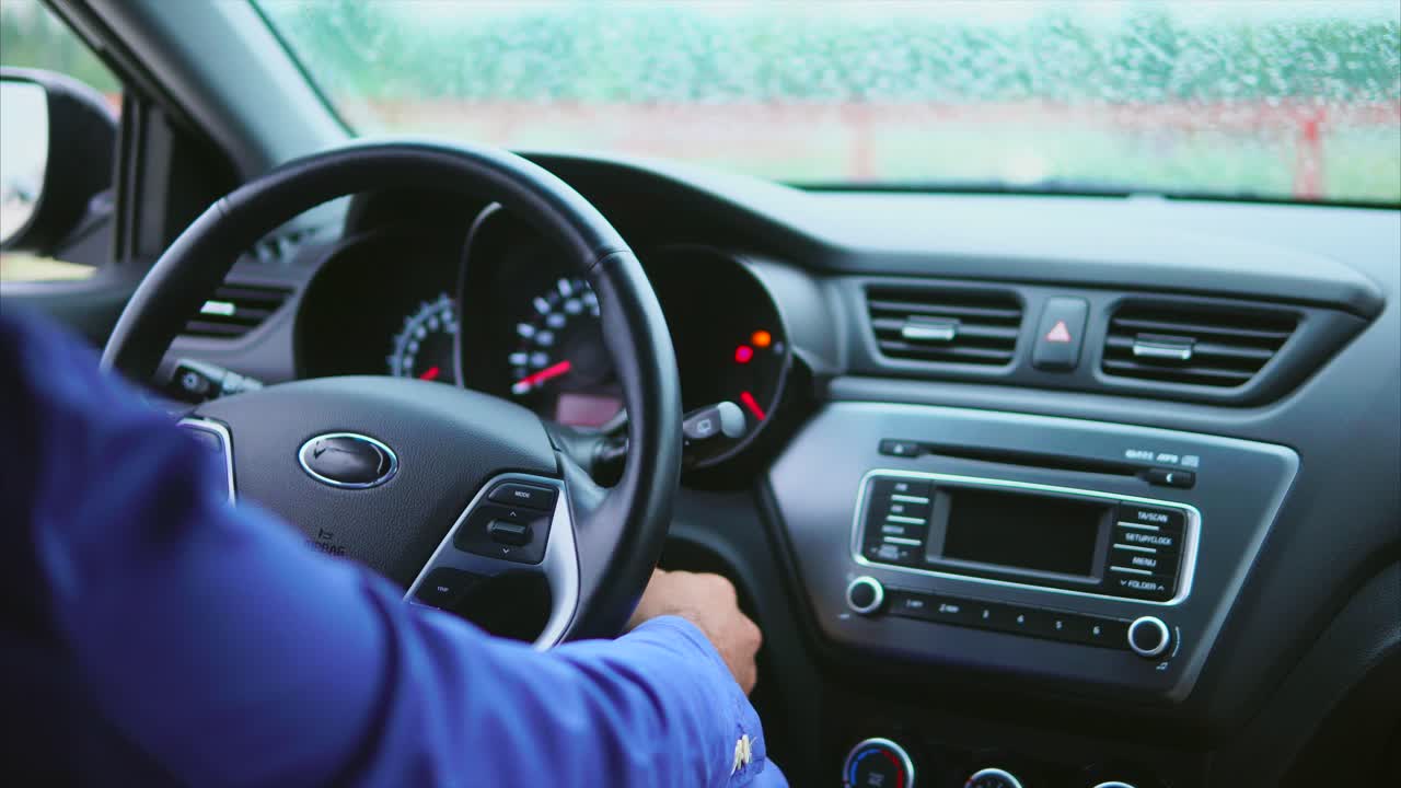 Person driving a car on a rainy day