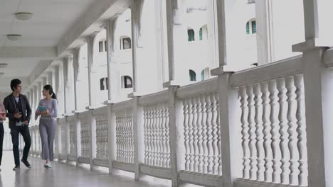 three students walking indoors at school. people going classroom for study. concept of education exam.