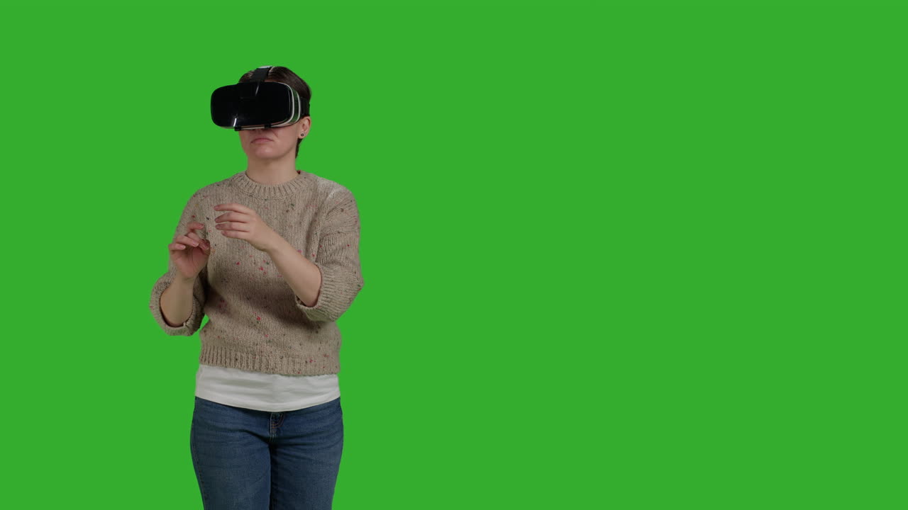 Woman using virtual reality headset on green screen