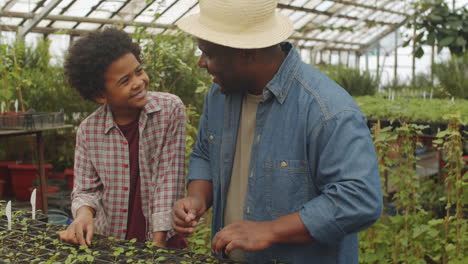 Black-Farmer-Working-in-Greenhouse-with-Little-Son
