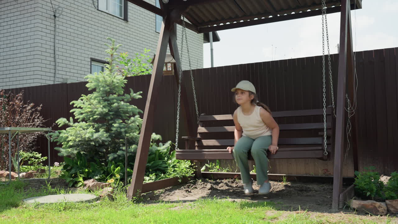 Woman Enjoying Peaceful Summer Day Outdoors, Woman In Casual Attire Relaxing On Wooden Swing In Backyard Setting, Serene Woman Dressed Casually Leaning Back On Swing Amidst Sunny Garden Scenery