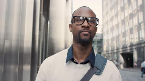 african american businessman walking through city