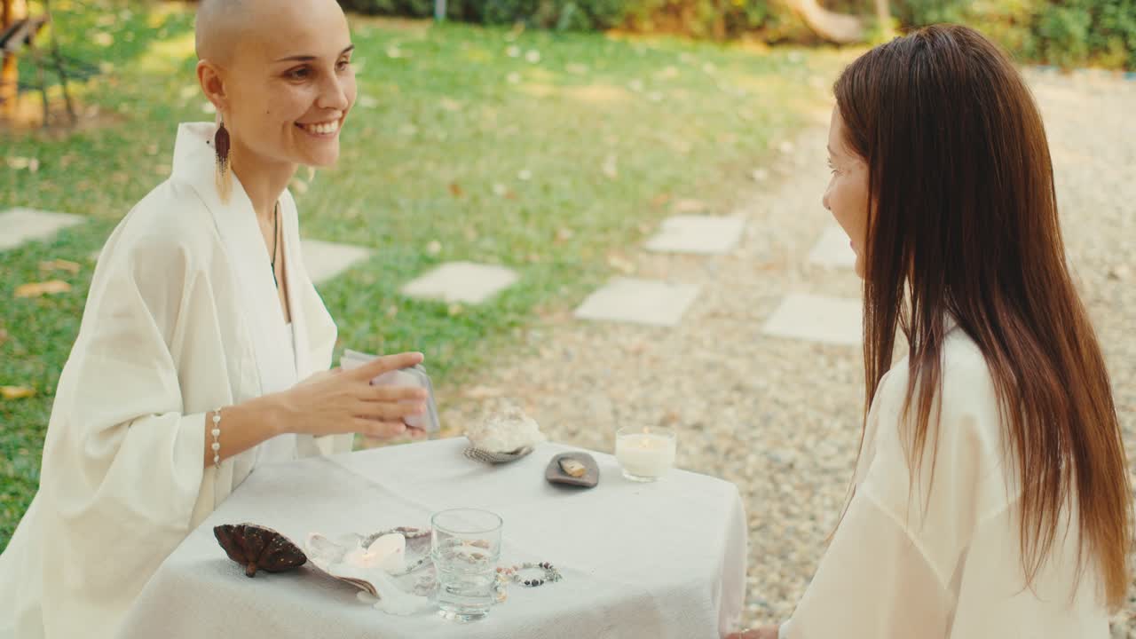 Women enjoying a tarot reading outdoors