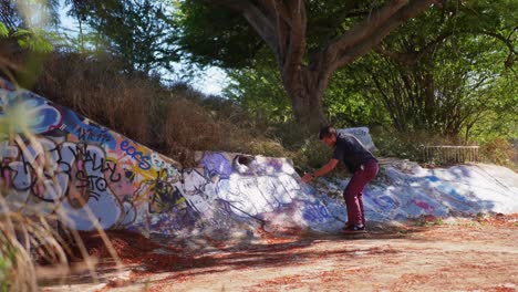 man does a skateboard trick in a ditch in hawaii