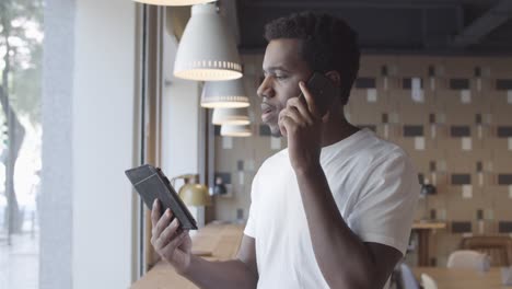 confident handsome young man talking on mobile phone