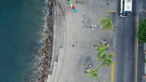 aerial video featuring a bird's-eye view of puerto vallarta's boardwalk, capturing the stunning coastline with waves crashing on the shore