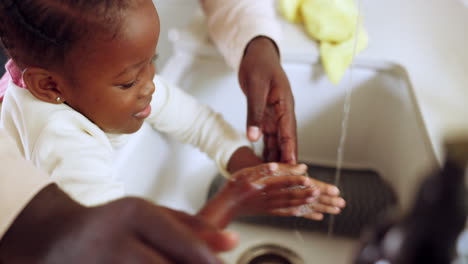 parent help girl to clean hands