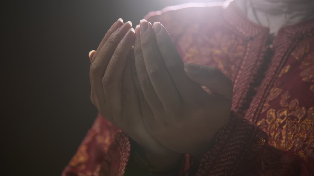 Close Up Studio Shot Showing Hands Of Muslim Woman Wearing Hijab Praying