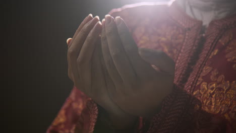 Close-Up-Studio-Shot-Showing-Hands-Of-Muslim-Woman-Wearing-Hijab-Praying