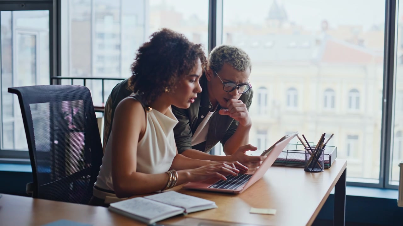 Multiethnic business partners discussing project office laptop working together
