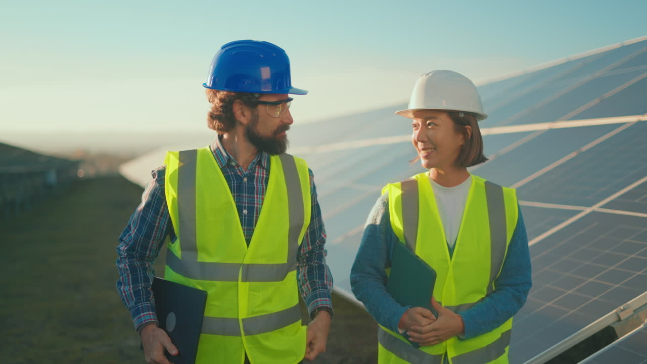 Engineers Inspecting Solar Panels at a Solar Farm