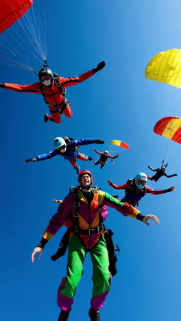 exhilarated skydivers in freefall against a bright blue sky