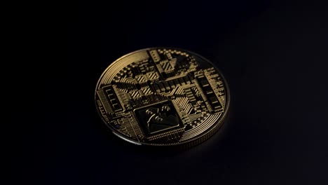 golden bitcoin spinning clockwise going from bright to dark on a dark background