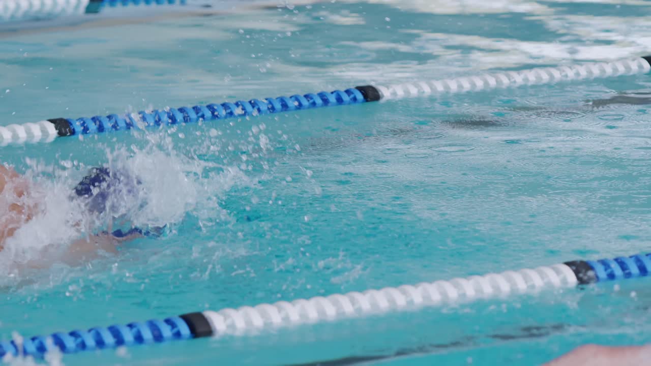 Svømmere svømmer ned i poolen