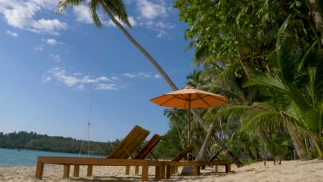 beach beds with umbrella on white sandy beach