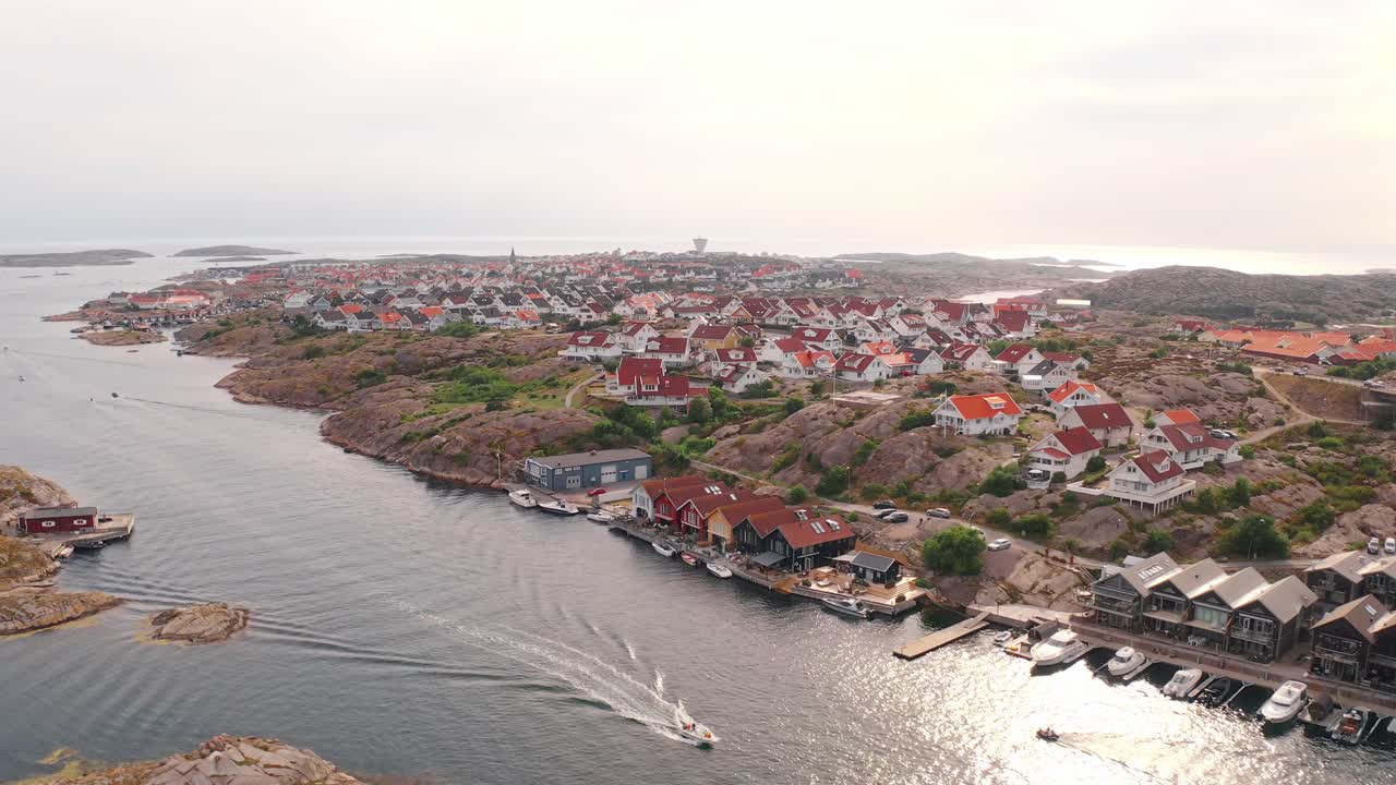 Coastal village in norway with colorful houses and rocky terrain, aerial view
