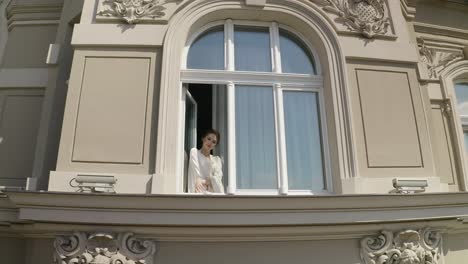 Aerial-shot-of-bride-in-boudoir-dress-stay-near-window-wedding-morning-of-woman-in-night-gown,-veil