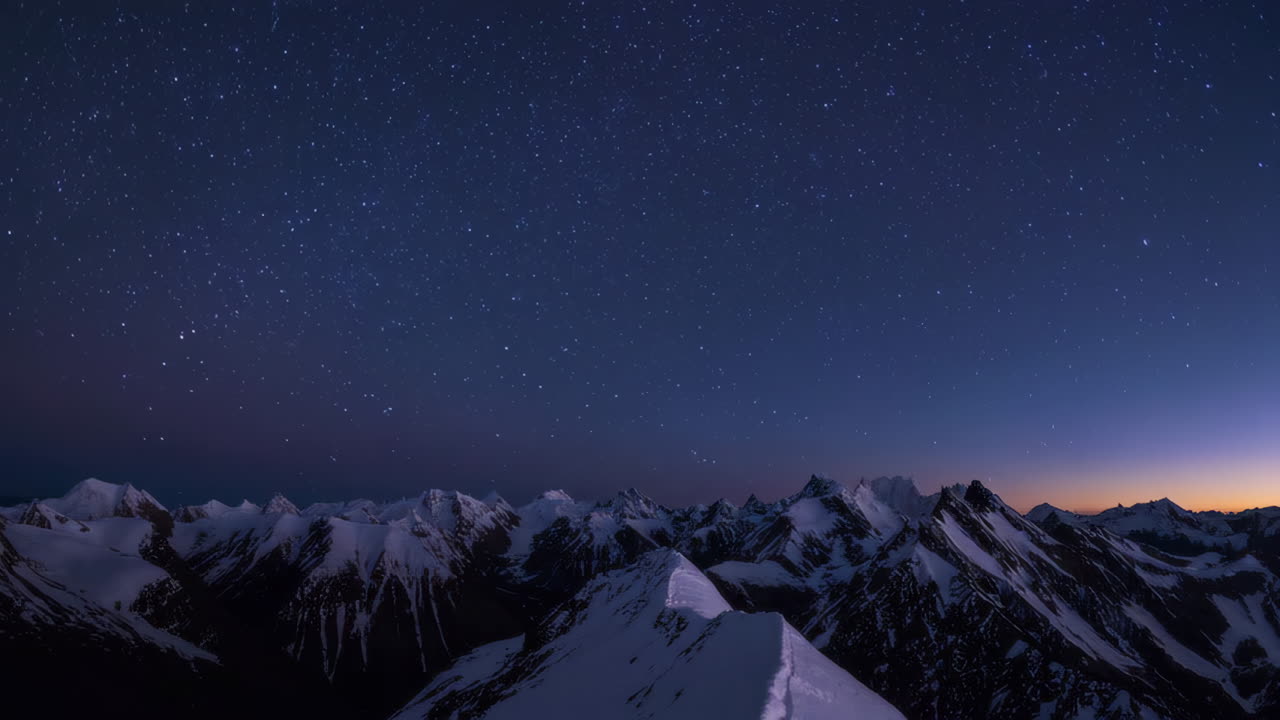 Starry Night Over Snowy Mountain Peaks | Premium Stock Video Footage