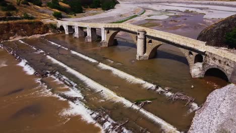 tomada en órbita aérea que muestra el puente de piedra de sarakina cerca de meteora en grecia