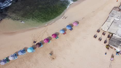 Aerial-view-of-white-sand-beach-and-colorful-umbrella
