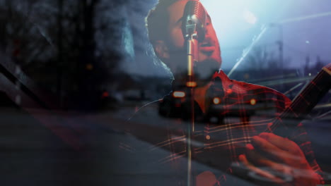 male singer strumming guitar on music stage, overlaying rainy street scene with glowing taillights