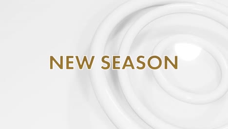 animation of new season in white and gold text over white rings on white background