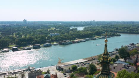 aerial shot circling around the spire of holy archangel michael orthodox church in belgrade, serbia