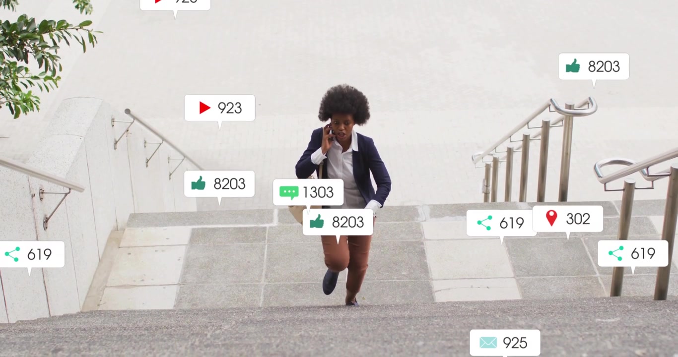 Businesswoman starting climb talking on phone monitoring social media metrics rising around her