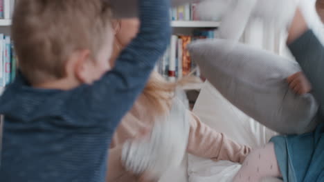 happy-family-having-pillow-fight-mother-and-father-enjoying-playing-with-children-at-home-having-fun-together-on-weekend-4k-footage