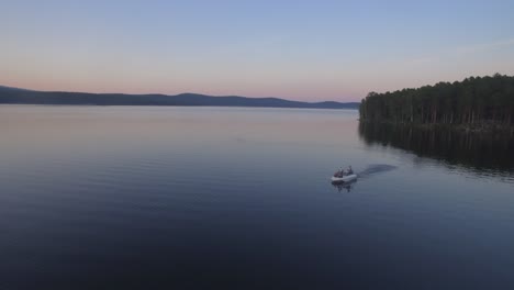 boat on a calm lake at sunset