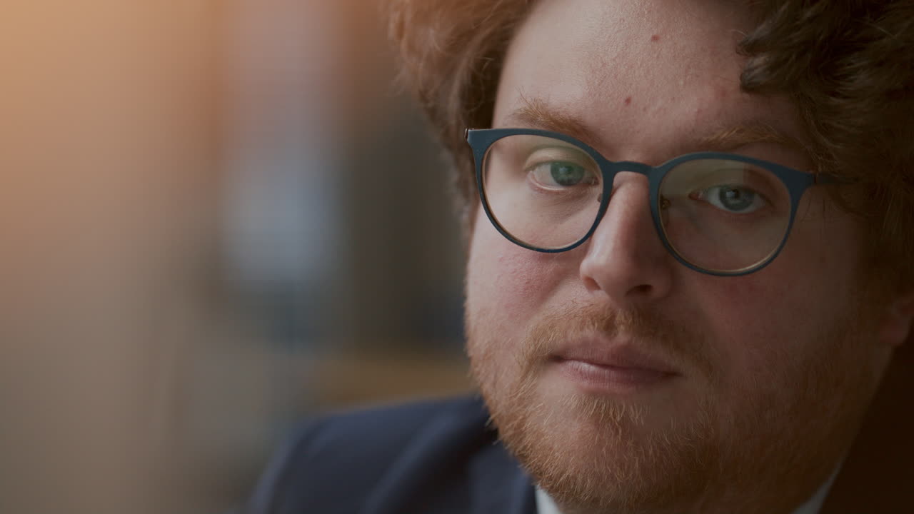 Portrait of Young Thoughtful Businessman in Glasses