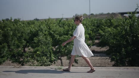 woman walking through an orchard
