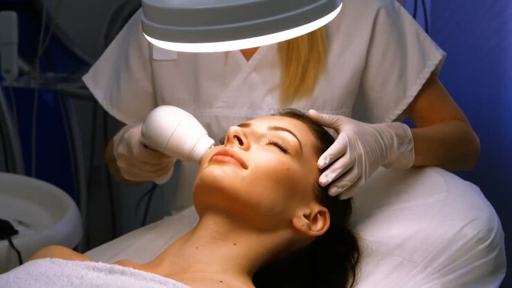 Doctor giving facial massage through soniclifting